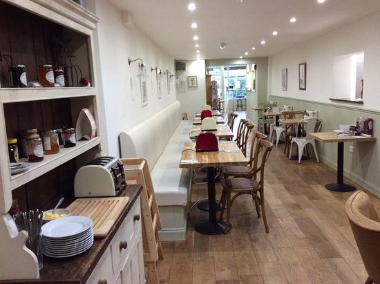 Custom-designed banquette seating and individual toasters on each table.